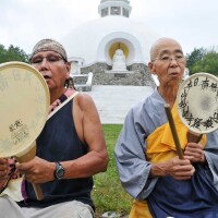 Larry Bringing Good, left, and Jun Yasuda, a Buddhist nun, use fan drums outside the Grafton Peace Pagoda on Thursday, July 30, 2015.    (Paul Buckowski / Times Union)